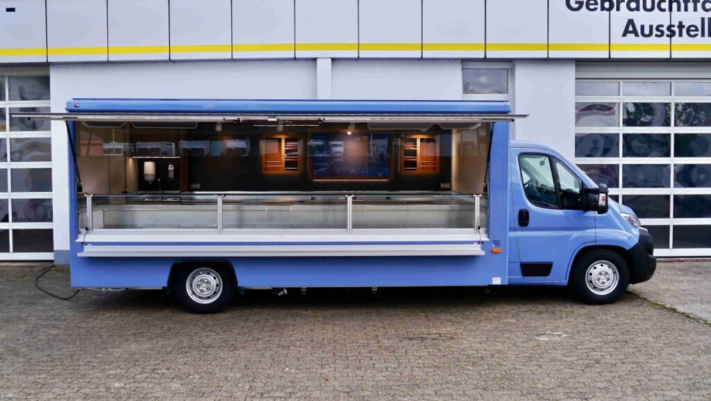 Arbeitsfläche,Hygienepaket nach DIN 10500,Kühltruhe,Verkaufskühltheke 37°C OPTIMA PLUS (5,00 m),BÄRO-LED Leuchten,HO-LED Lichtband,Beifahrerdoppelsitzbank,Seitenblenden,Polyesterfußboden.