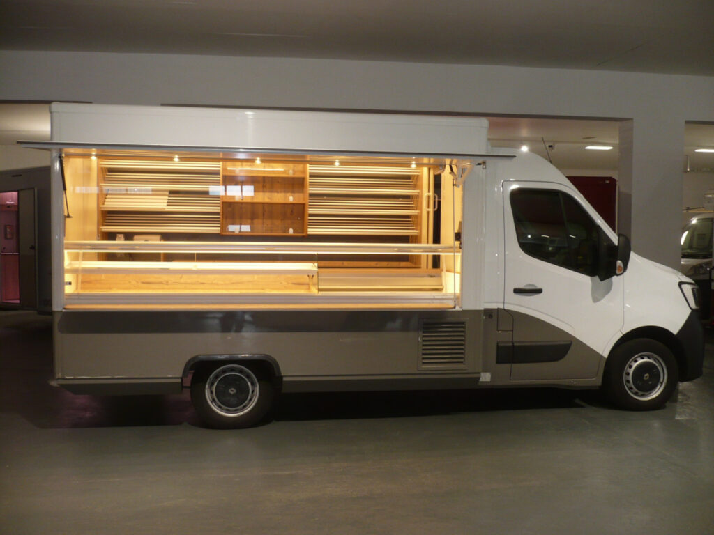 Lithium-Ionen-Batterie, LED-Beleuchtung, Präsentationsregal, Thekenarbeitsplatz mit Kassenschublade, Schneideplatte, Messerabstreifbehälter, fester Einstiegstritt an Heckseite